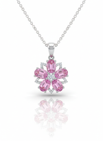A sterling silver necklace with a flower-shaped pendant on a white background. The pendant features six oval-cut pink gemstones for petals, a central white diamond, and small accent diamonds, with a soft reflection below.