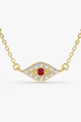 A delicate gold chain necklace featuring a horizontal, eye-shaped pendant paved with clear, sparkling stones and a single round, red gemstone in the center.